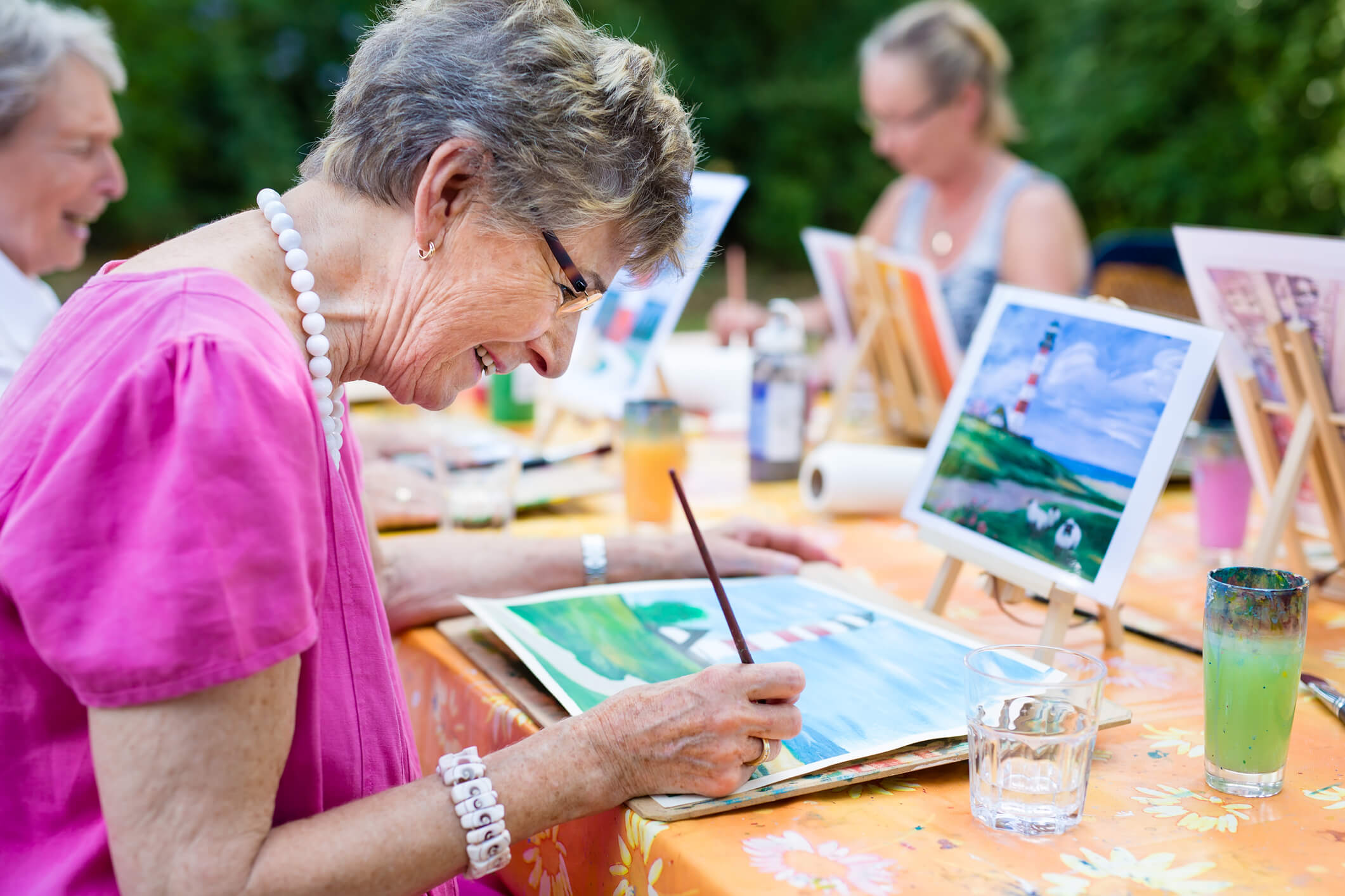 Ältere Dame lernt in Zeichenkurs kreativ zu sein